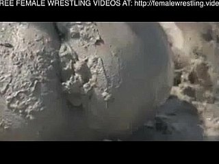 Girls wrestling in someone's skin mud